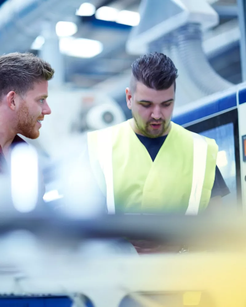 employees talking in industry hall