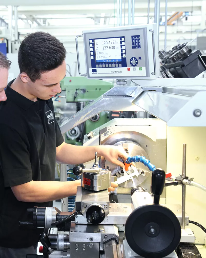 two employees working on clippiing machine