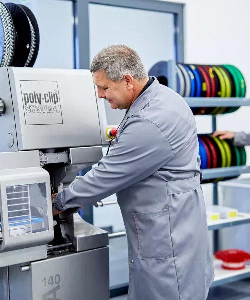 employees in front of machine consumables 