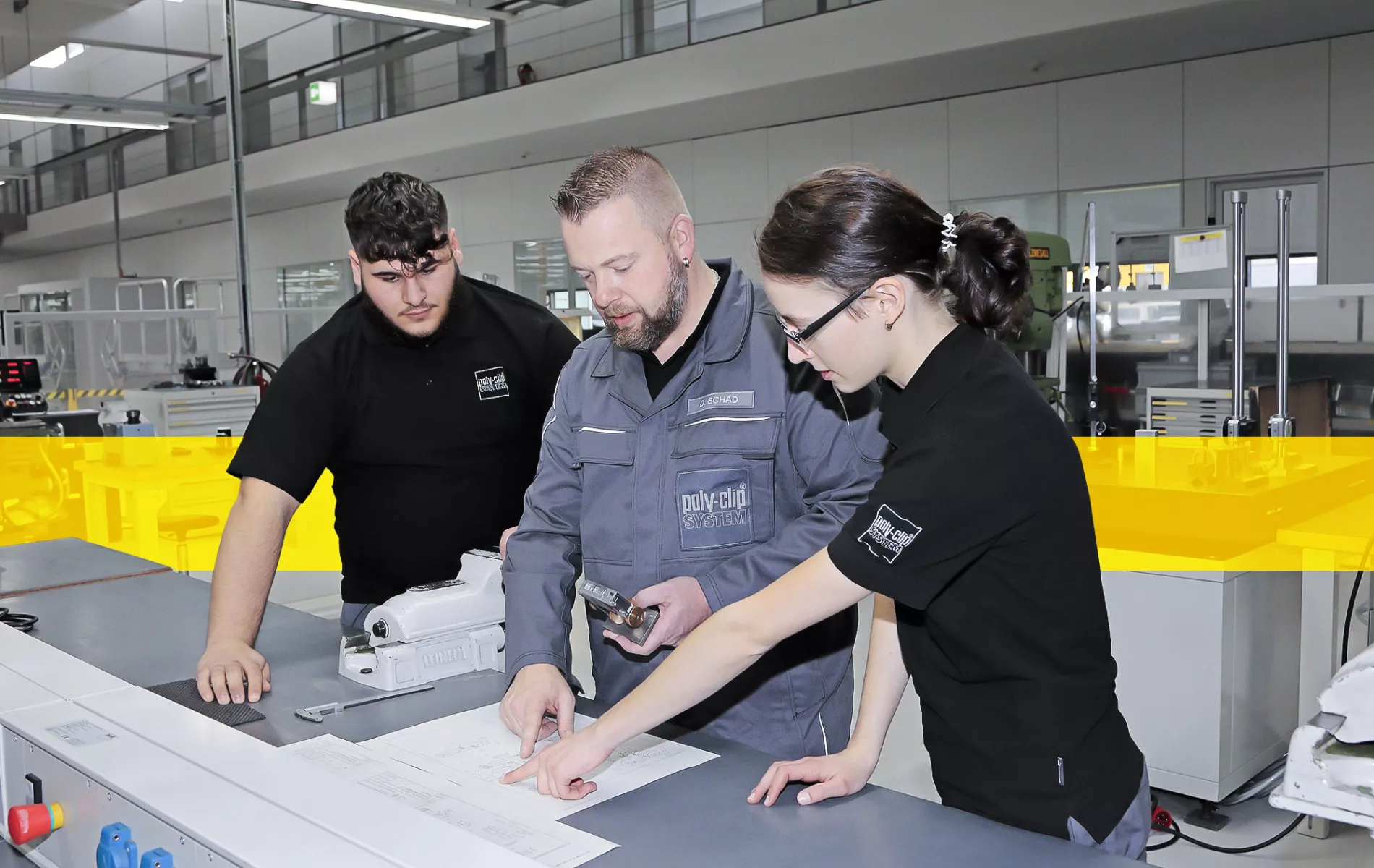 one worker and two trainees inside fabric hall